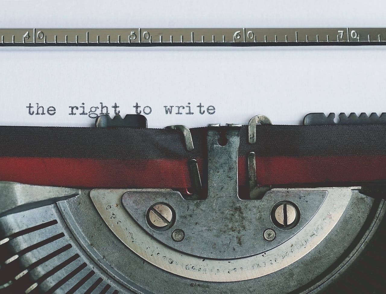 Close-up of a vintage typewriter with the right to write typed on paper.